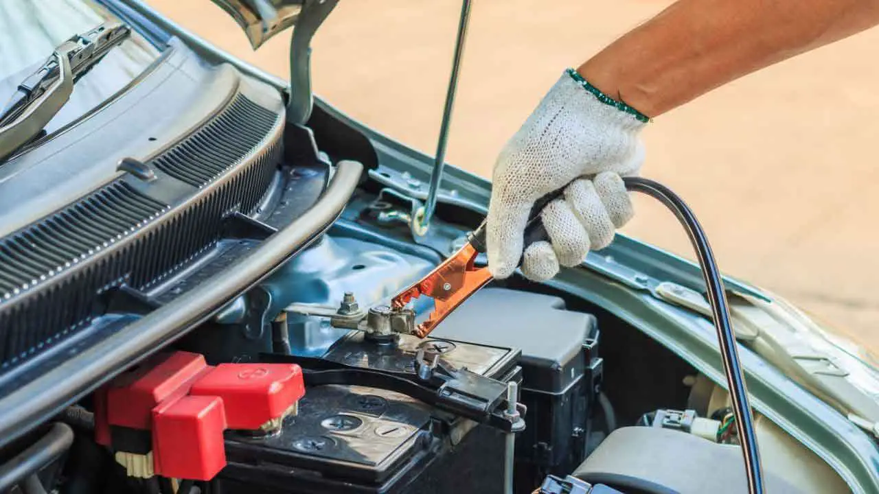 connected jumper cables with car battery