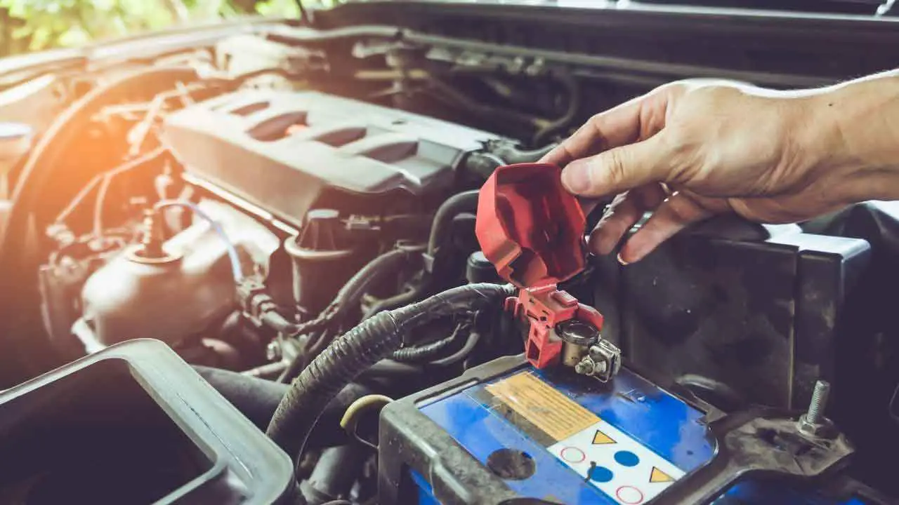 mechanic checking car battery for problems